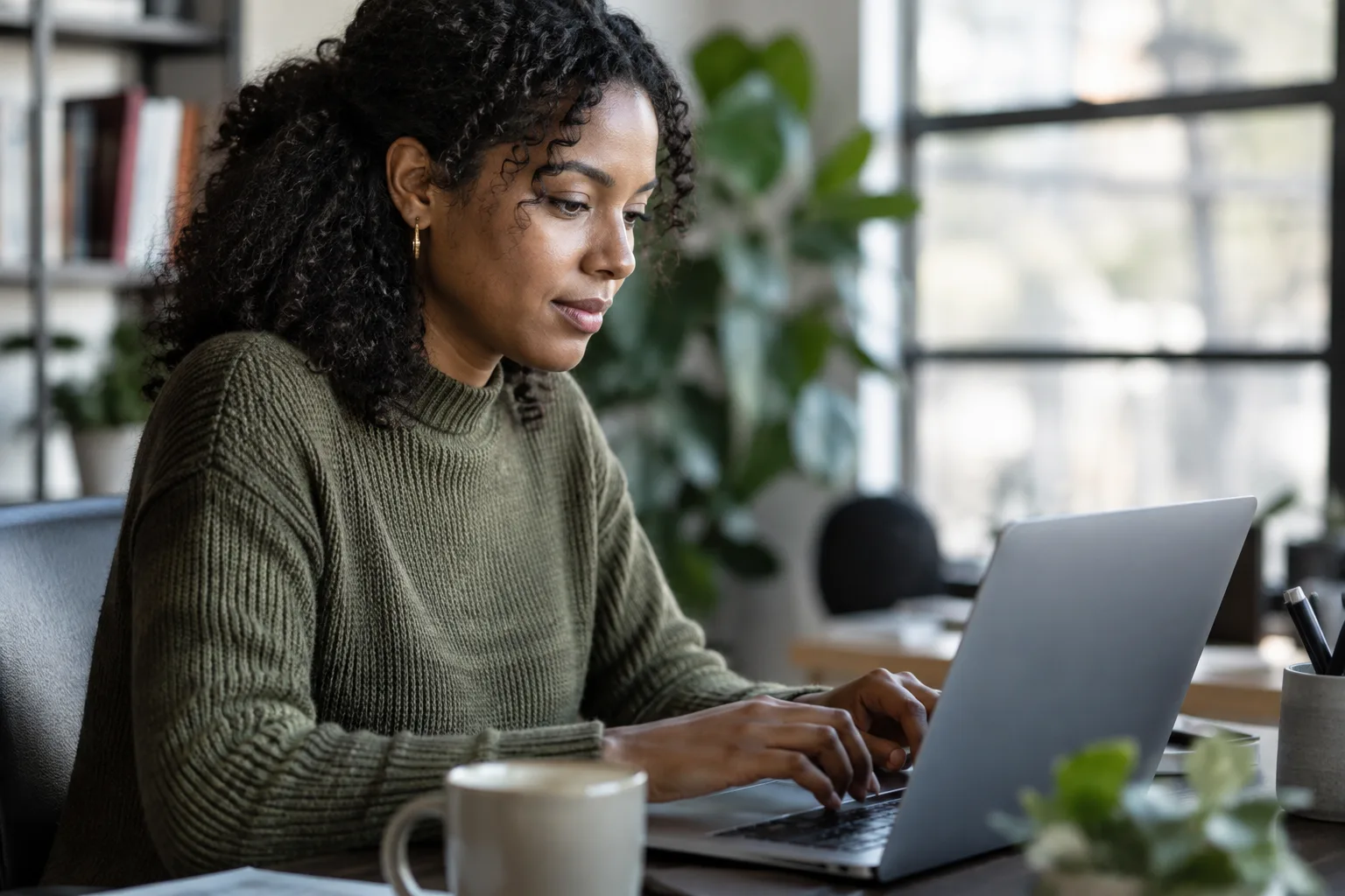 A photograph of someone composing a short personalized message on a laptop.